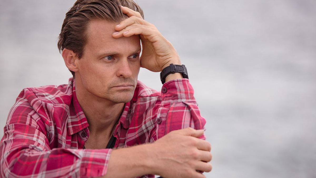 A thoughtful man sitting outdoors