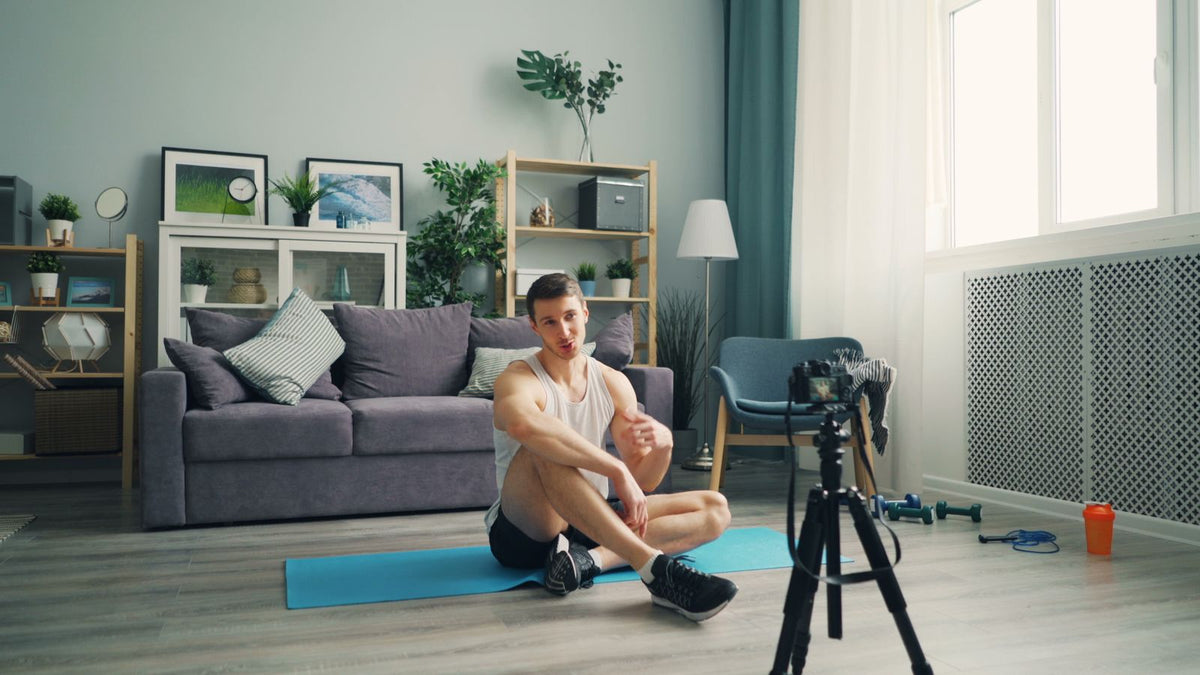 Man exercising on a mat in a bright living room