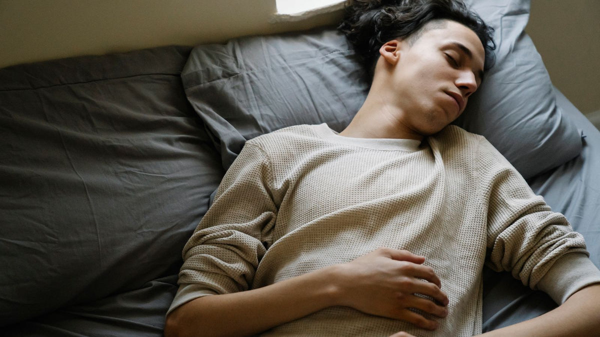 A tired man resting in bed