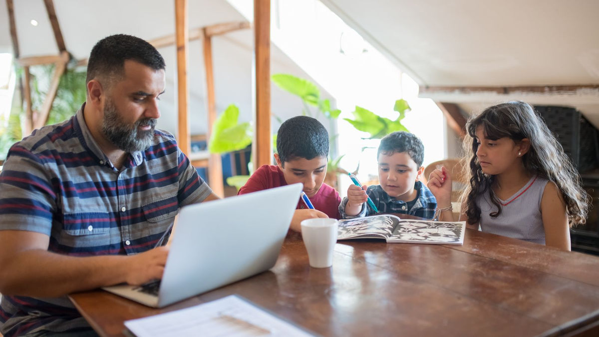 A parent juggling a laptop and childcare