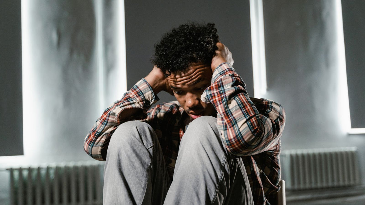 A man sitting with his head in his hands